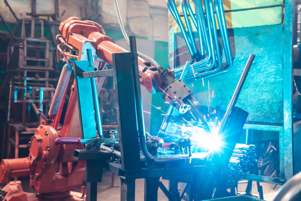 A robot produces sparks as it welds a product